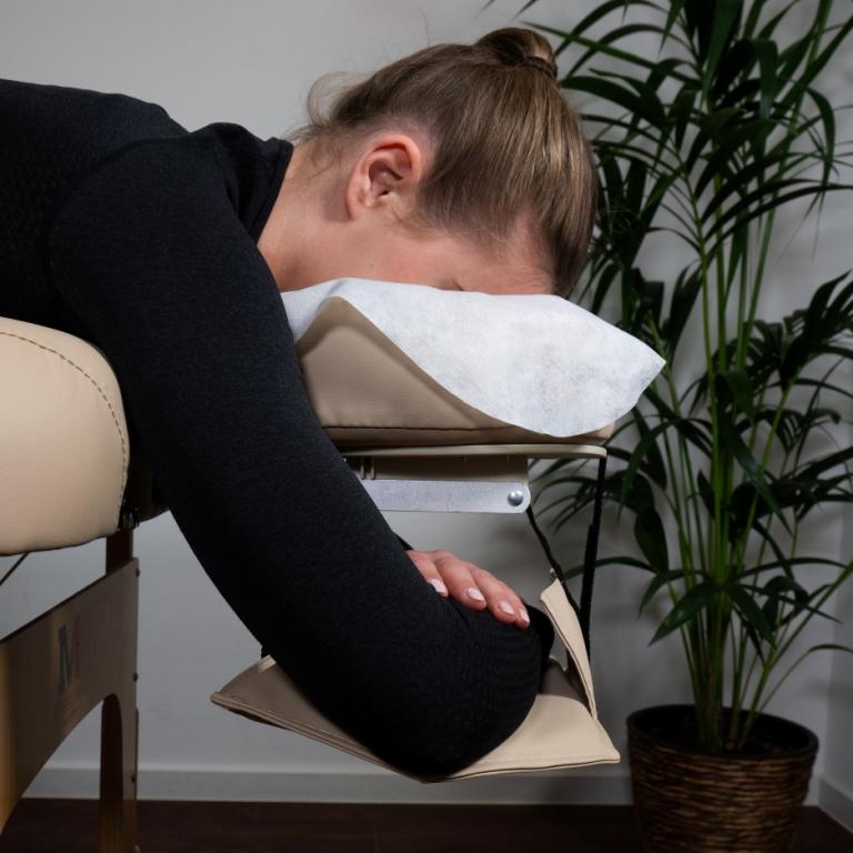 Massage table arm loop on the headrest